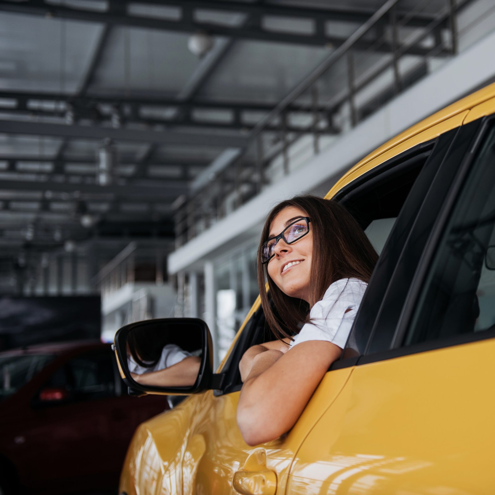 young woman in her new car smiling 2023 11 27 05 18 31 utc scaled